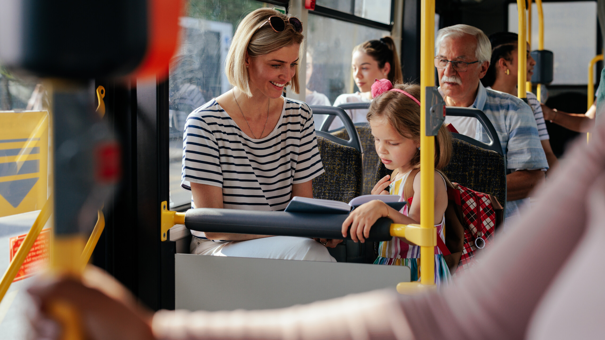 Mom and daughter riding bus