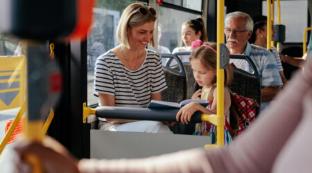 Mom and daughter riding bus