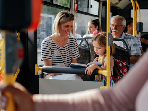 Mom and daughter riding bus