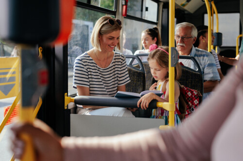 Mom and daughter riding bus