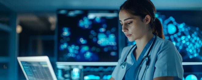 Focused Doctor Working on Laptop in Blue Lit Medical Office